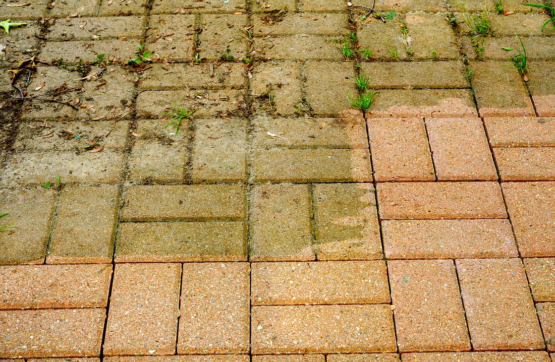 Before and after pressure washing residential brick surface 